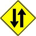 A highway with two - way traffic is marked by which sign ?
