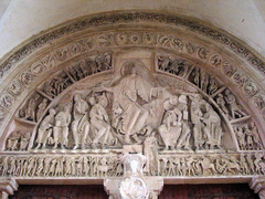 In the context of Romanesque architecture, a tympanum refers to: