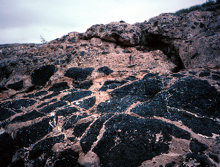 This photograph shows an upper light-colored conglomerate and a lower dark basalt. Which of the following statements is true?