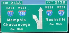 What are the colors of a sign which tells you the distance to the next exit of a highway ?
