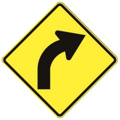 What does a black curved arrow on a yellow sign mean ?