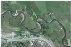 Which of the features on this aerial photograph is an oxbow lake?